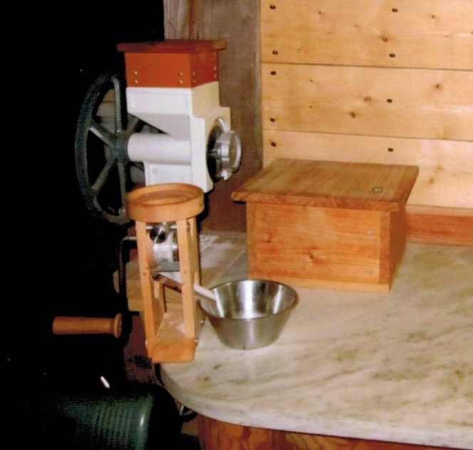 Notice the custom wood hopper extension and flour bin with lid.
